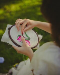 Woman Hands Holding Handmade Plate with Sewed Flower